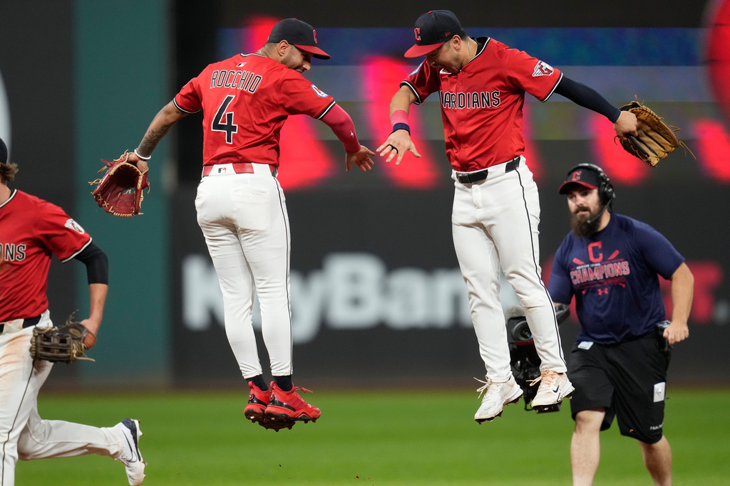 Cleveland Guardians' Brayan Rocchio (4) and left fielder Steven Kwan, right, celebrate after the Guardians defeated the Detroit Tigers in ia baseball game in Cleveland, Tuesday, Sept. 23, 2025. (AP Photo/Sue Ogrocki)