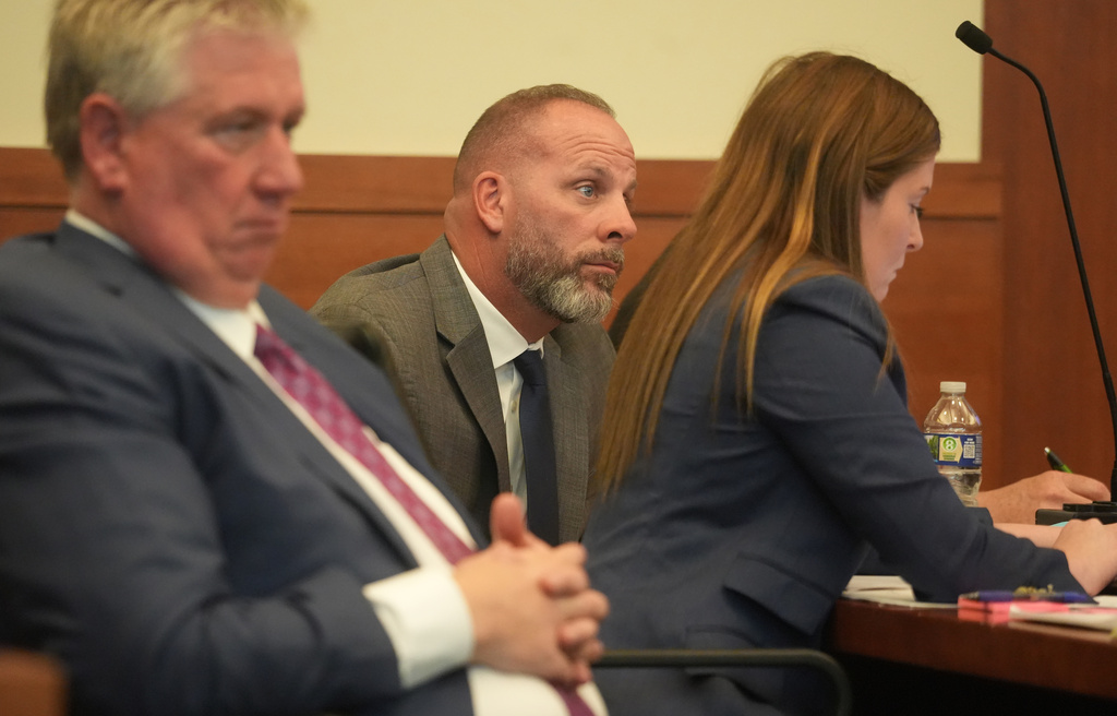 Jason Meade, center, sits with his attorneys Mark Collins, left, and Kaitlyn Stephens, right, during opening statements in the retrial of the former Ohio sheriff's deputy charged with murder and reckless homicide in the 2020 killing of Casey Goodson Jr., inside Franklin County Common Pleas Court in Columbus, Ohio, Thursday, April 23, 2026. (Doral Chenoweth/Pool photo via AP)