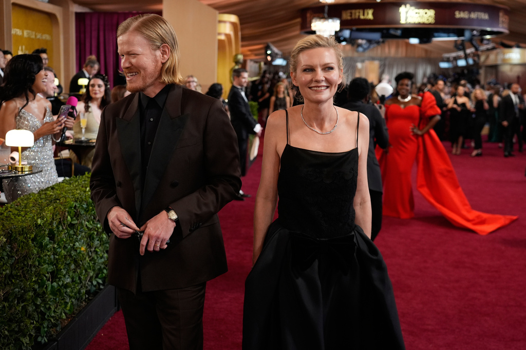 Jesse Plemons, left, and Kirsten Dunst arrive at the 32nd Annual Actor Awards on Sunday, March 1, 2026, at the Shrine Auditorium and Expo Hall in Los Angeles. (AP Photo/Chris Pizzello)
