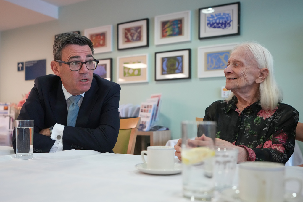 Britain's Prime Minister Andy Burnham speaks to a resident as he visits a care home in London, Wednesday, July 29, 2026.(AP Photo/Kirsty Wigglesworth, Pool)