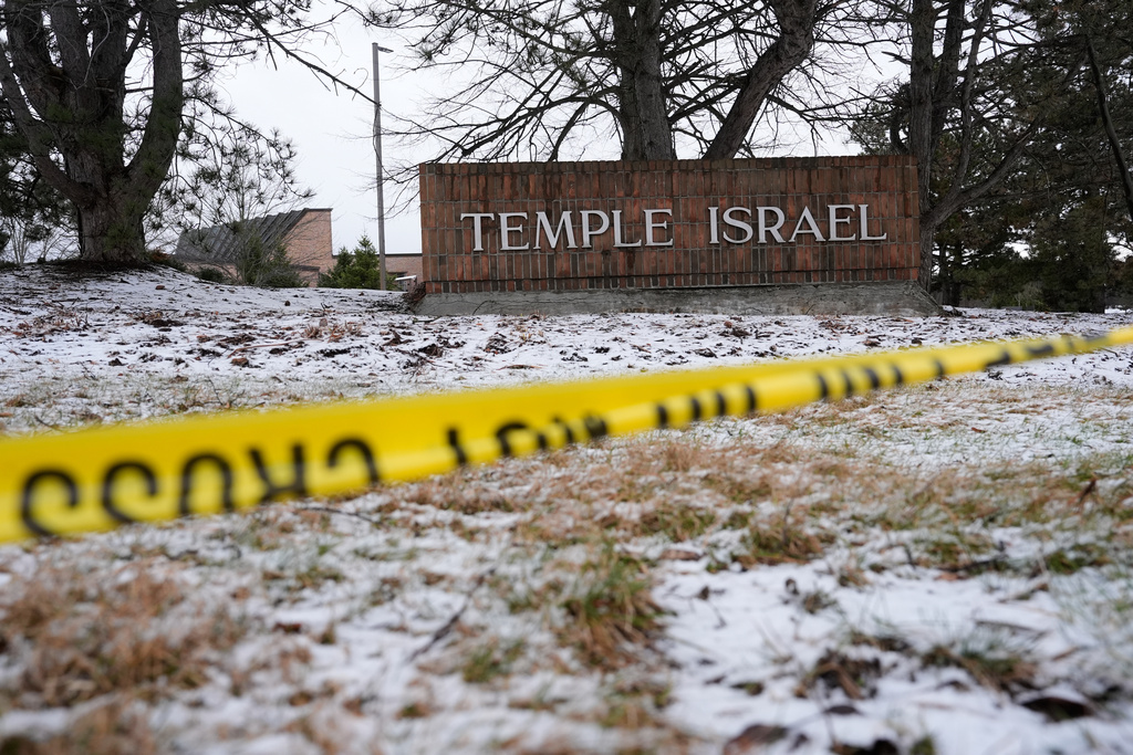 Police tape hangs outside the Temple Israel synagogue Friday, March 13, 2026, in West Bloomfield Township, Mich. (AP Photo/Paul Sancya)