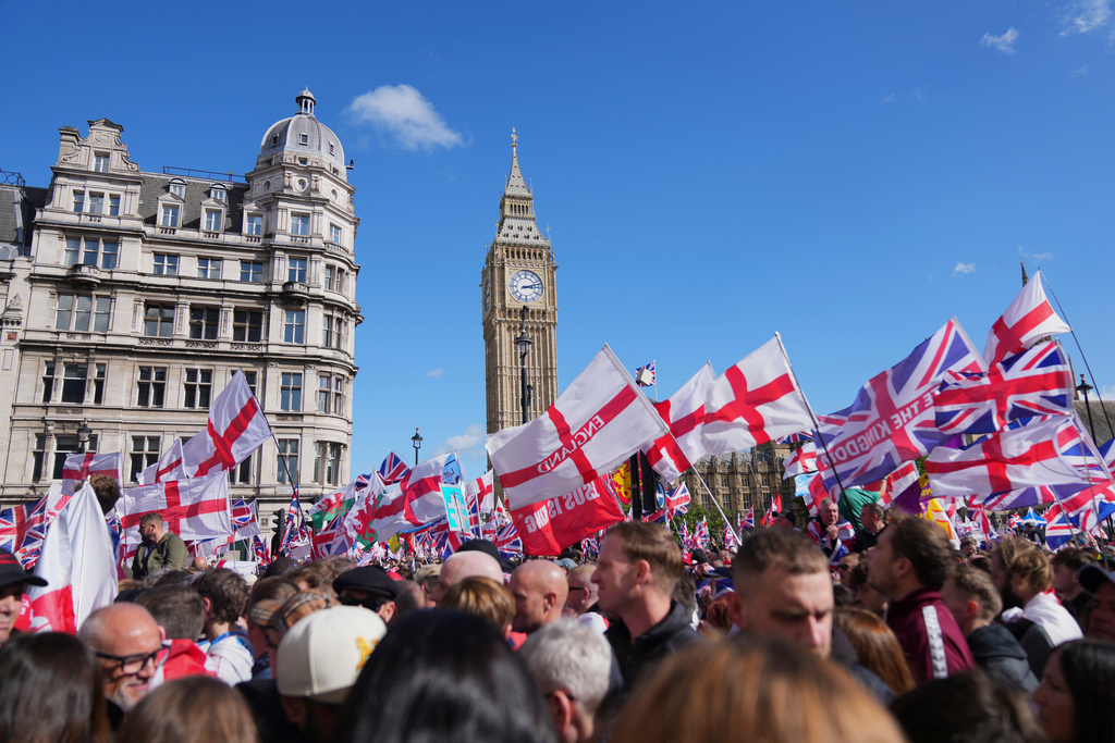 FILE - People demonstrate during the Tommy Robinson-led Unite the Kingdom march and rally, in London, Saturday Sept. 13, 2025. (AP Photo/Joanna Chan, File)