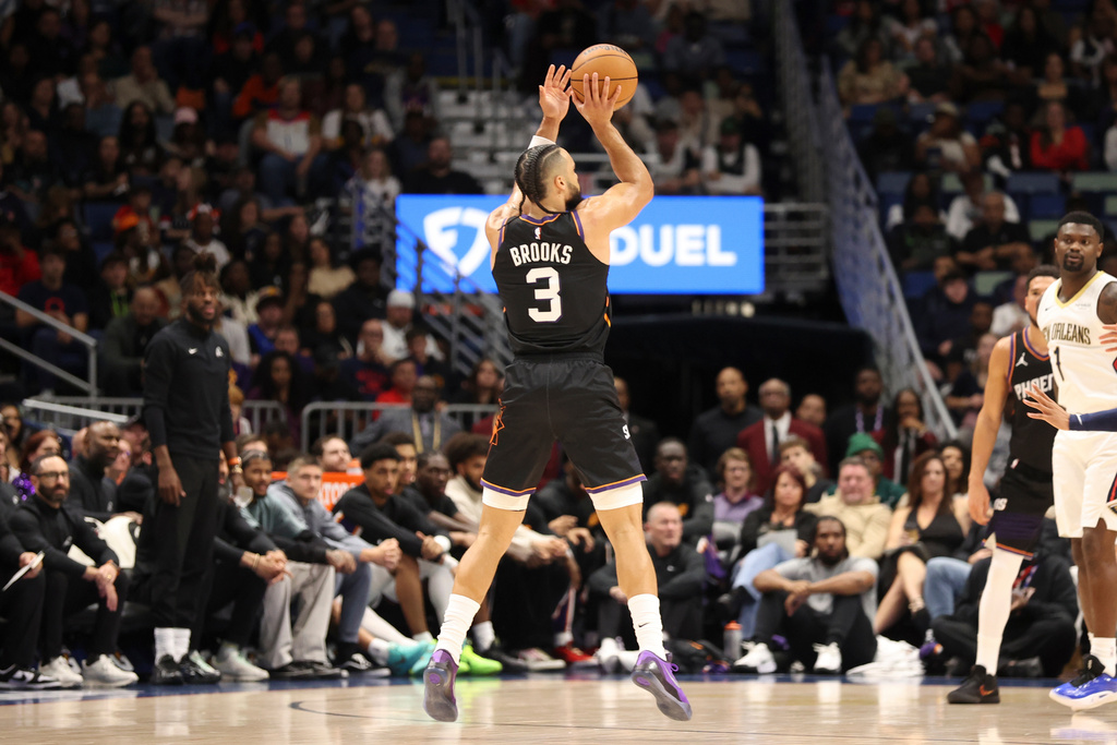 Phoenix Suns forward Dillon Brooks (3) shoots a 3-point basket in the first half of an NBA basketball game against the New Orleans Pelicans, Friday, Dec. 26, 2025, in New Orleans. (AP Photo/Peter Forest)