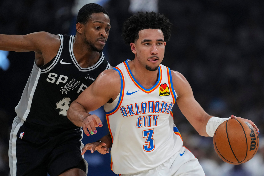 Oklahoma City Thunder guard Jared McCain (3) drives against San Antonio Spurs guard De'aaron Fox (4) in the first half of Game 5 in the Western Conference finals NBA basketball playoffs series, Tuesday, May 26, 2026, in Oklahoma City. (AP Photo/Julio Cortez)