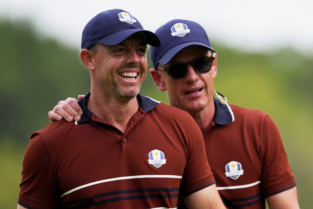 Europe captain Luke Donald and Rory McIlroy celebrates after a putt on the 15th hole at Bethpage Black golf course during the Ryder Cup golf tournament, Saturday, Sept. 27, 2025, in Farmingdale, N.Y. (AP Photo/Matt Slocum)