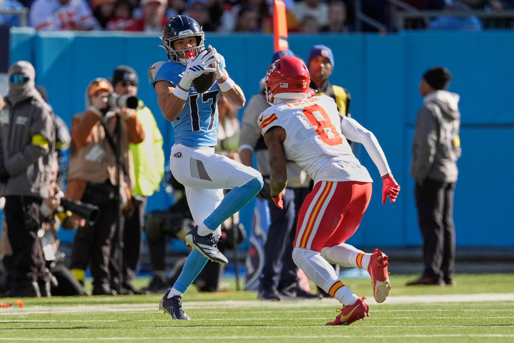 Tennessee Titans wide receiver Chimere Dike (17) catches a pass under pressure from Kansas City Chiefs cornerback Kristian Fulton (8) during the first half of an NFL football game Sunday, Dec. 21, 2025, in Nashville, Tenn. (AP Photo/George Walker IV)