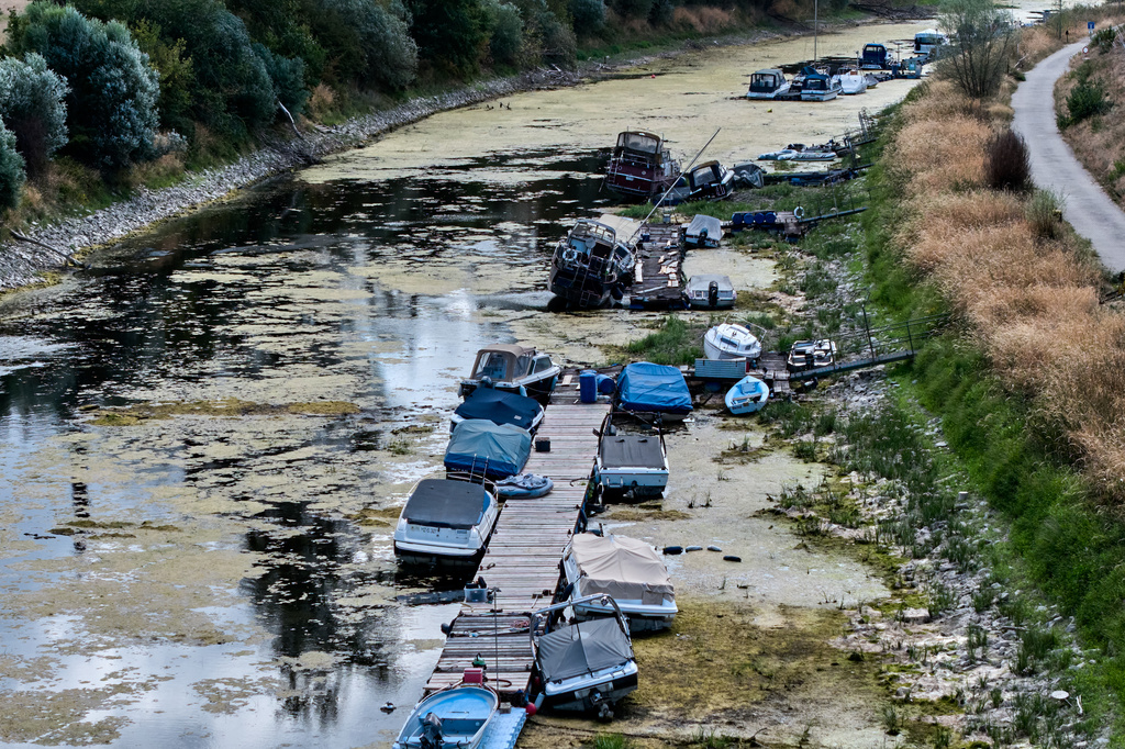 Boats are stranded in a side arm of the river Rhine that is running out of water in Mackenheim near Mainz, Germany Monday, Aug. 10, 2026. (AP Photo/Michael Probst)