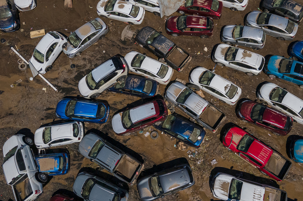 Damaged vehicles sit in mud after flooding in Poza Rica, Veracruz state, Mexico, Sunday, Oct. 12, 2025. (AP Photo/Felix Marquez)