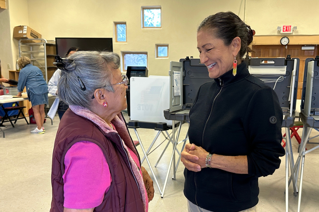 Democratic gubernatorial candidate Deb Haaland, right, talks with Dora Yazzie while visiting San Felipe Pueblo, N.M., on Tuesday, June 2, 2026. (AP Photo/Susan Montoya Bryan)