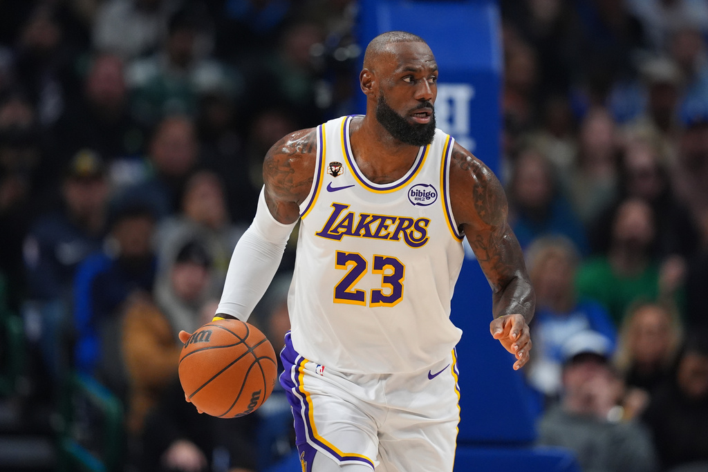 Los Angeles Lakers forward LeBron James dribbles the ball up court against the Dallas Mavericks during the first half of an NBA basketball game Saturday, Jan. 24, 2026, in Dallas. (AP Photo/Julio Cortez)