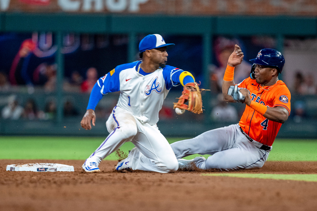 Houston Astros' Jesús Sánchez (4) steals second base from Atlanta Braves second baseman Ozzie Albies (1) during the third inning of a baseball game Saturday, Sept. 13, 2025, in Atlanta. (AP Photo/Erik Rank)