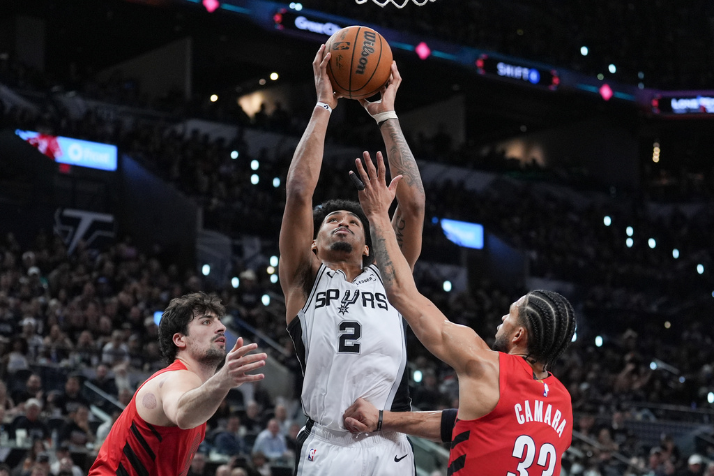 San Antonio Spurs guard Dylan Harper (2) goes to the basket as Portland Trail Blazers forward Deni Avdija, left, and Portland Trail Blazers forward Toumani Camara (33) defend during the second half in Game 5 of a first-round NBA playoffs basketball series in San Antonio, Tuesday, April 28, 2026. (AP Photo/Eric Gay)