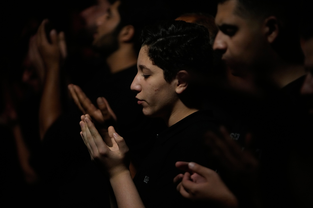 Iranians perform their evening prayers in a mourning ceremony in Tehran, Iran, Tuesday, June 23, 2026, prior to Ashoura, which commemorates the 7th-century martyrdom of Imam Hussein, one of Prophet Muhammad's grandsons and one of Shiite Islam's most beloved saints, and 72 of his companions, who were killed in a battle in Karbala in present-day Iraq. (AP Photo/Vahid Salemi)