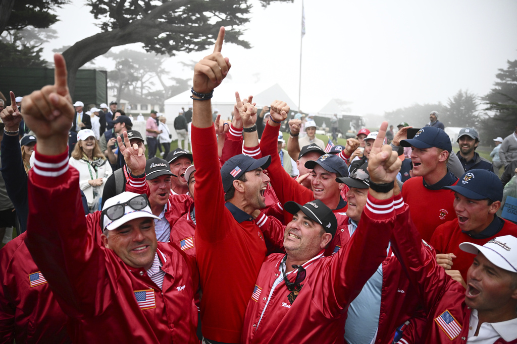 The USA team players and supporters celebrate after defeating the Great Britain and Ireland team in the Walker Cup golf tournament at Cypress Point Club on Sunday, Sept. 7, 2025, in Pebble Beach, Calif. (AP Photo/Thien-An Truong)