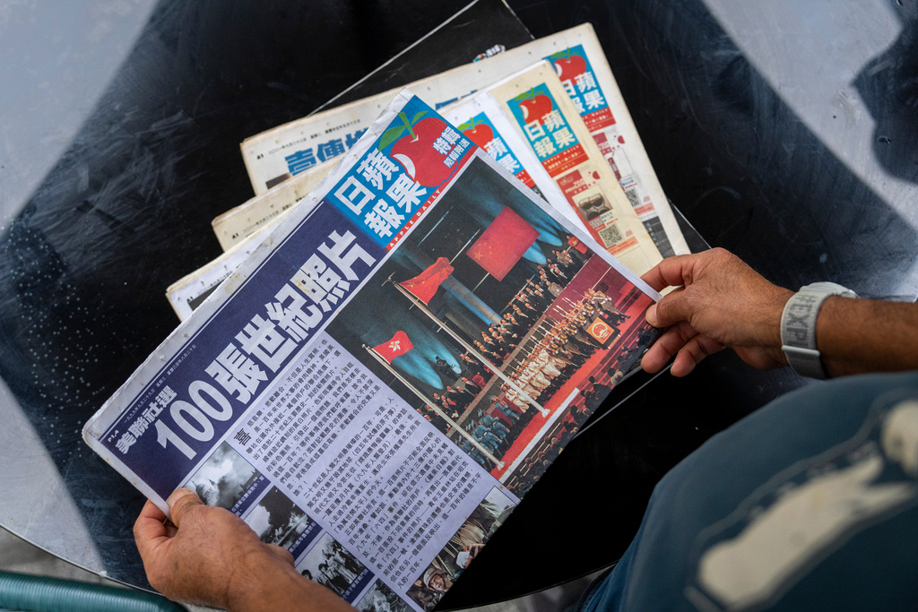 Former Apple Daily reader William Wong places some copies of Apple Daily on the table during an interview with The Associated Press in Hong Kong, Jan. 30, 2026. (AP Photo/Chan Long Hei)