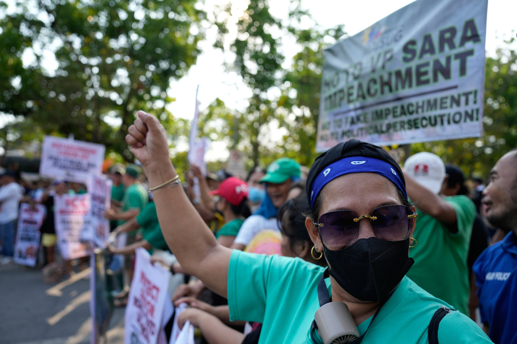 A supporter of former Senator Ronald dela Rosa and Vice President Sara Duterte gestures as they hold a rally outside the Philippine Senate in Pasay, Philippines on Tuesday, May 12, 2026. (AP Photo/Aaron Favila)