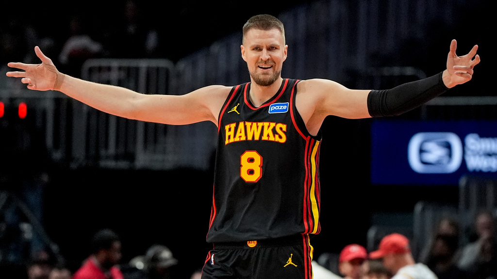 Atlanta Hawks center Kristaps Porzingis (8) reacts to play against the Toronto Raptors during the first half of an NBA basketball game, Friday, Nov. 7, 2025, in Atlanta. (AP Photo/Mike Stewart)