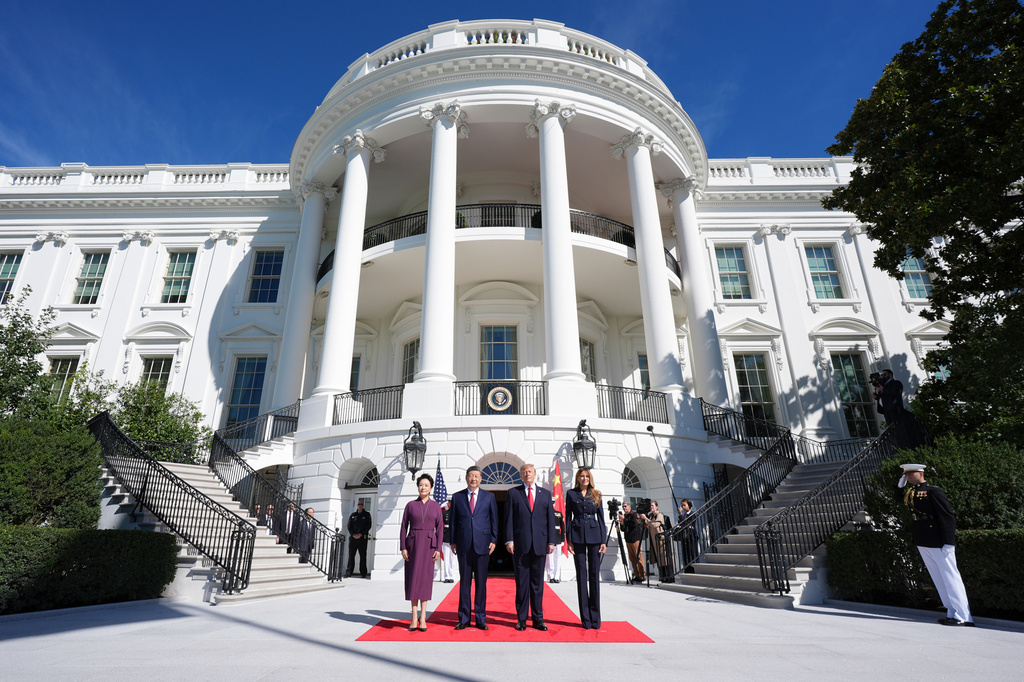 President Donald Trump, center right, and first lady Melania Trump, right, pose as they greet China's President Xi Jinping, center left, and his wife Peng Liyuan, as they arrive at the South Portico of the White House for tea, Friday, Sept. 25, 2026, in Washington. (AP Photo/Jacquelyn Martin)