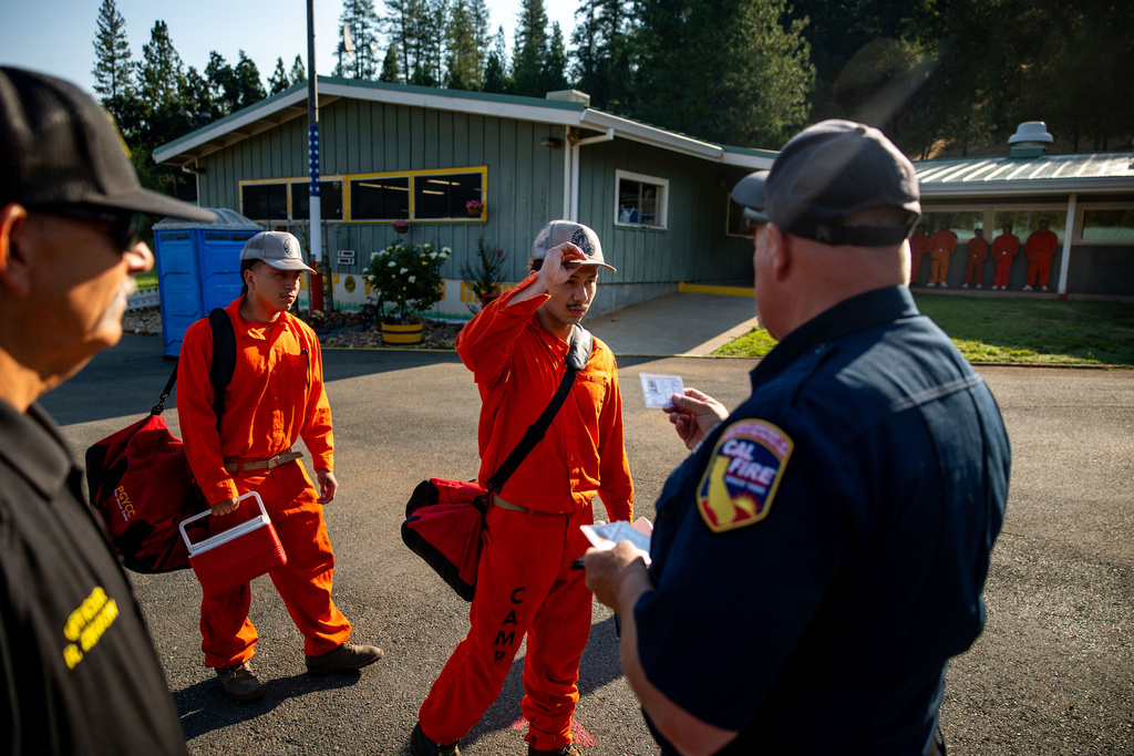 A participant in the Youth Offender Program Camp Pilot Program lines up before work at the Pine Grove Youth Conservation Camp, July 14, 2025, in Red Corral, Calif. (AP Photo/Ethan Swope)
