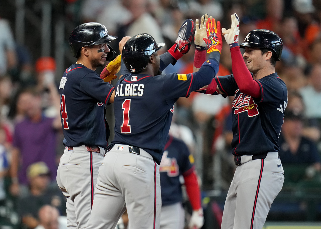 Atlanta Braves' Mike Yastrzemski, right, celebrates after his three-run home run with Mauricio Dubon, left, and Ozzie Albies, center, during the sixth inning of a baseball game against the Houston Astros, Sunday, Sept. 20, 2026, in Houston. (AP Photo/Karen Warren)