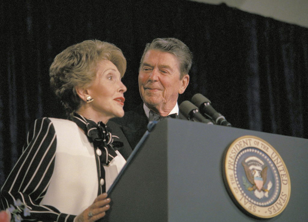 FILE - President Ronald Reagan watches as first lady Nancy Reagan comments from the podium during the White House Correspondents' Association annual dinner on April 23, 1987, in Washington. (AP Photo/Charles Tasnadi, File)