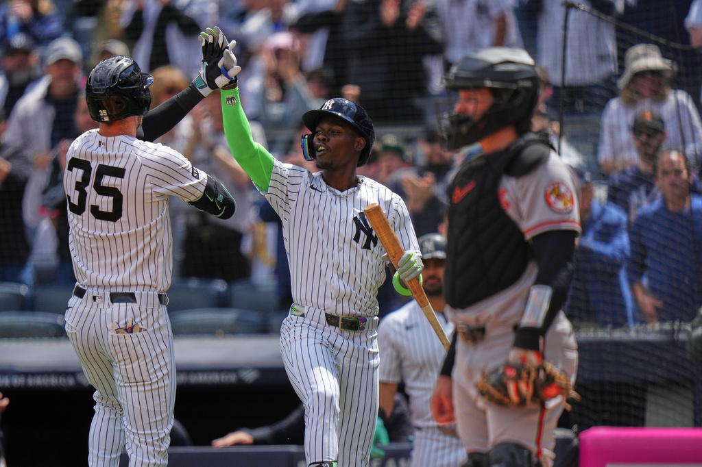 New York Yankees' Cody Bellinger, left, celebrates with teammate Jazz Chisholm Jr. as Baltimore Orioles catcher Adley Rutschman, right, looks away during the second inning of a baseball game Saturday, May 2, 2026, in New York. (AP Photo/Frank Franklin II)