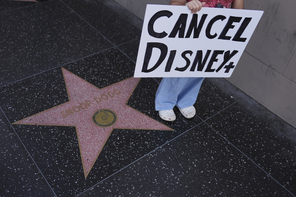 A demonstrator holds a sign reading "CANCEL DISNEY+" outside El Capitan Entertainment Centre, where the late-night show "Jimmy Kimmel Live!" is staged, Thursday, Sept. 18, 2025, in Los Angeles. (AP Photo/Jae C. Hong)