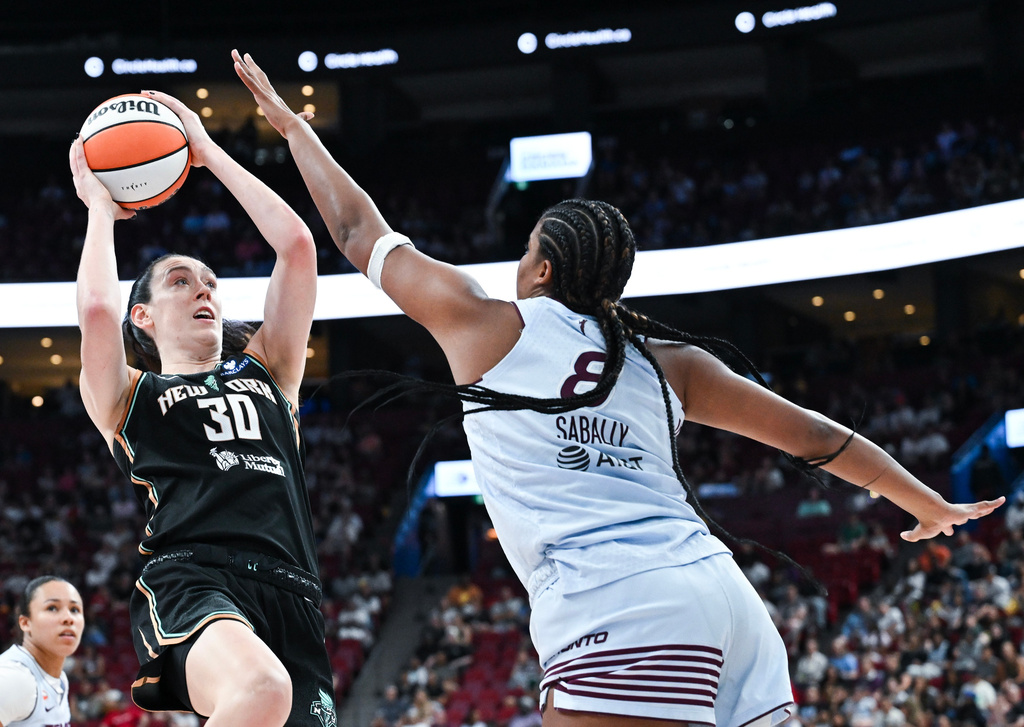 Toronto Tempo's Nyara Sabally (8) defends against New York Liberty's Breanna Stewart (30) during the second half of a WNBA basketball game in Montreal, on Sunday, July 12, 2026. (Graham Hughes/The Canadian Press via AP)