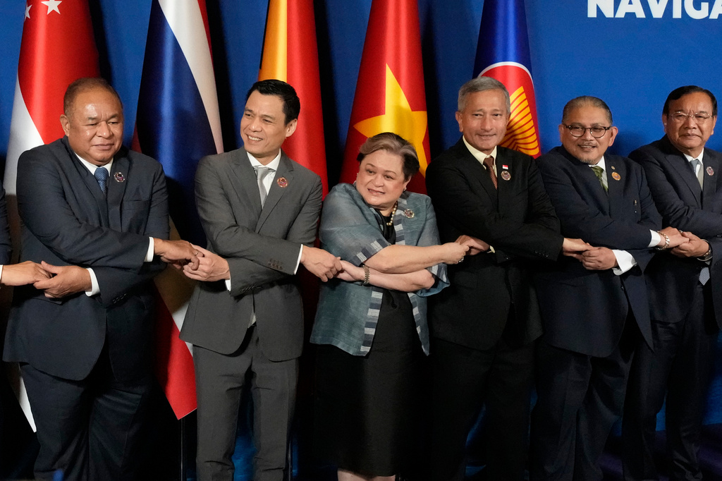 From left, East Timor's Foreign Minister Bendito dos Santos Freitas, Vietnam's Deputy Minister of Foreign Affairs Dang Hoang Giang, Philippine's Foreign Secretary Theresa Lazaro, Singapore's Foreign Minister Vivian Balakrishnan, Brunei's Second Foreign Minister Erywan Pehin Yusof, and Cambodia's Foreign Minister Prak Sokhonn hold hands during a group photo session at the ASEAN Foreign Ministers' Meeting at the Mactan Expo in Cebu province, central Philippines on Thursday, May 7, 2026. (AP Photo/Aaron Favila, Pool)