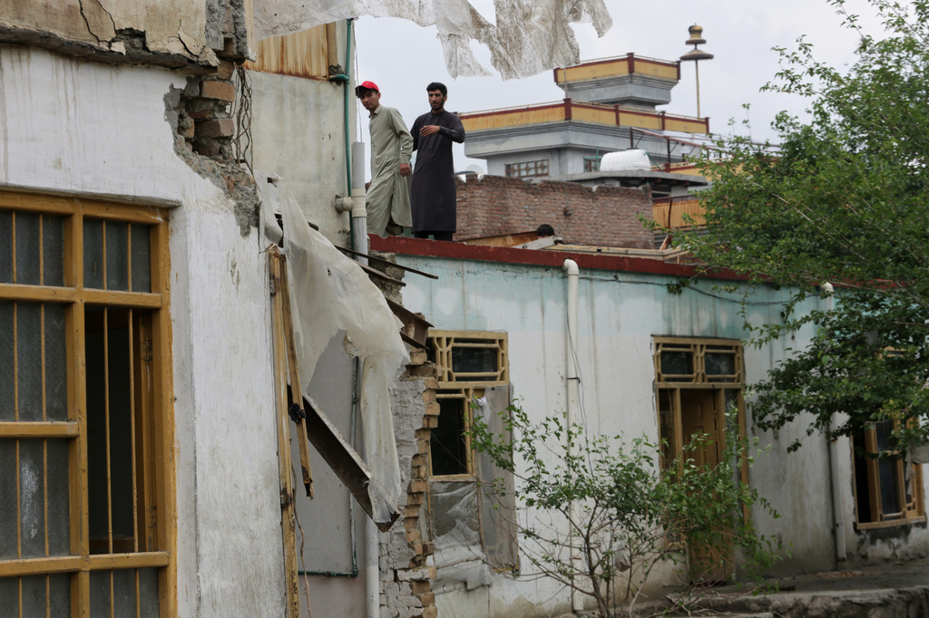 Residents inspect a building damaged by heavy flooding in Jalalabad, Afghanistan, Saturday, April 4, 2026. (AP Photo/Wahidullah Kakar)