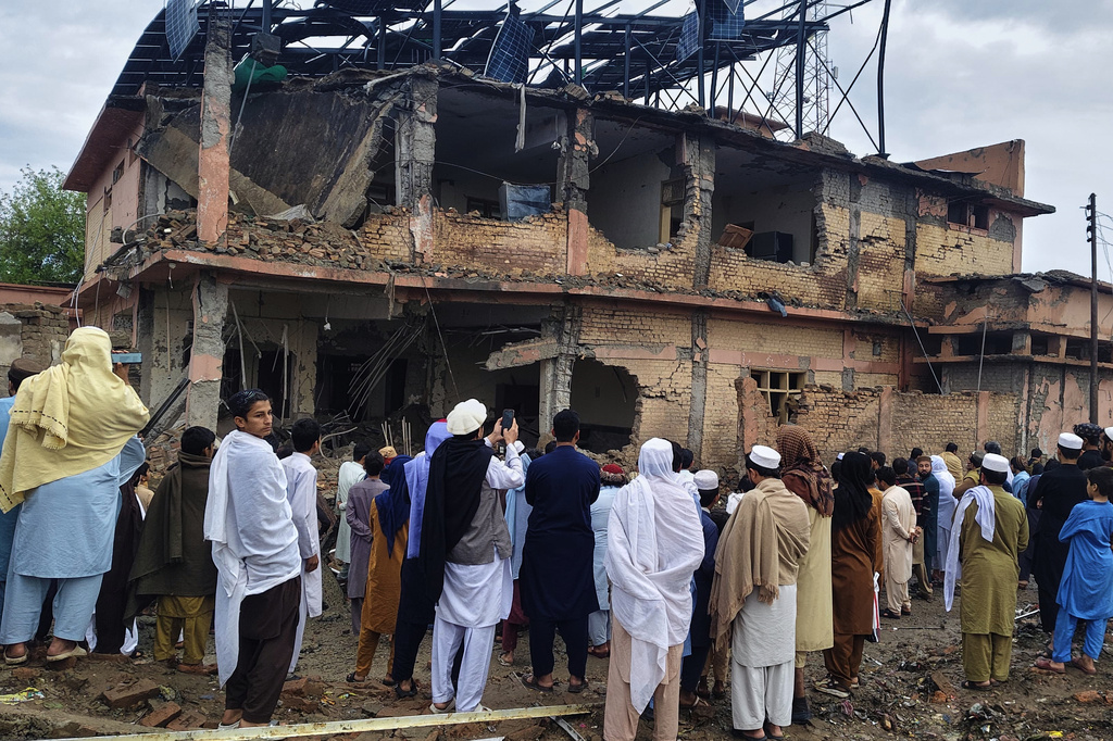 Local residents look at the damaged portion of a police station at the site of an overnight suicide bombing, in Bannu, a district of northwestern Pakistan, Friday, April 3, 2026. (AP Photo/Amaad Khattak)