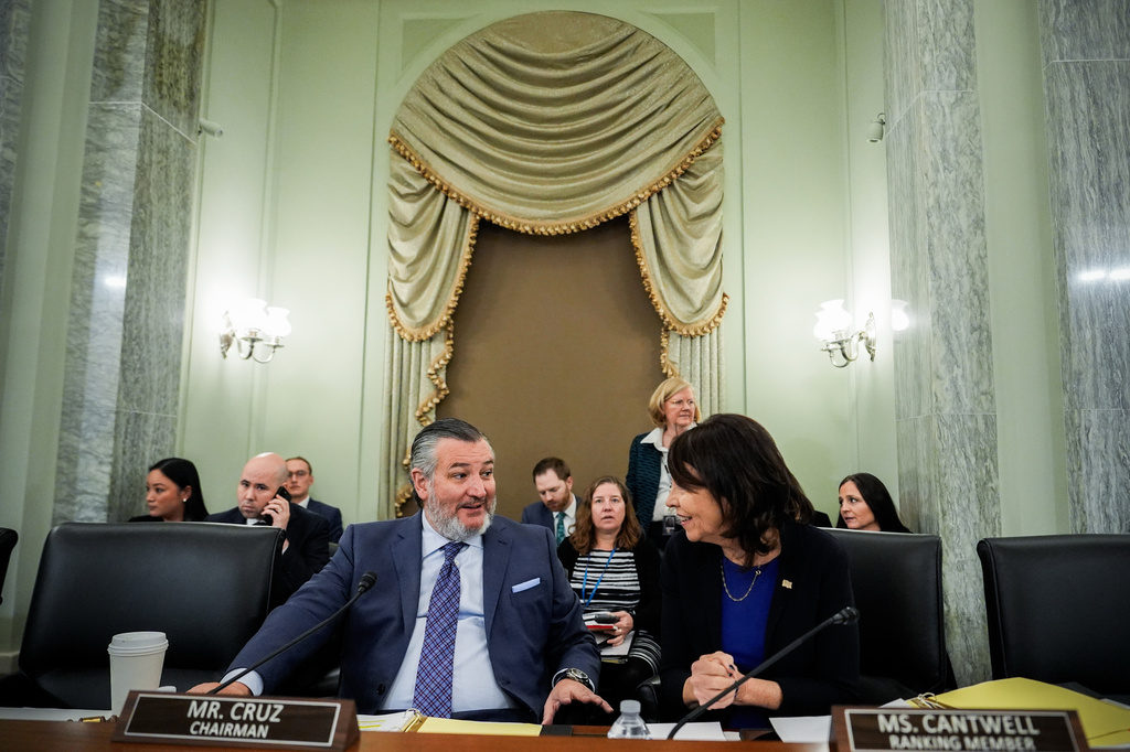 FILE - Sen. Ted Cruz, R-Texas, left, chairman of the Senate Commerce, Science and Transportation Committee, speaks with Sen. Maria Cantwell, D-Wash., right, before a hearing Wednesday, Nov. 19, 2025, on Capitol Hill in Washington. (AP Photo/Julia Demaree Nikhinson,File)
