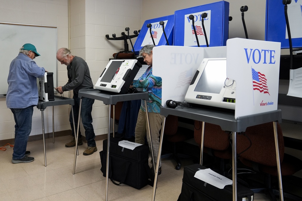 FILE - Poll workers set up ballot-marking machines at an early in-person voting site at Asheville-Buncombe Technical Community College, Wednesday, Oct. 16, 2024, in Marshall, N.C. (AP Photo/Stephanie Scarbrough,File)
