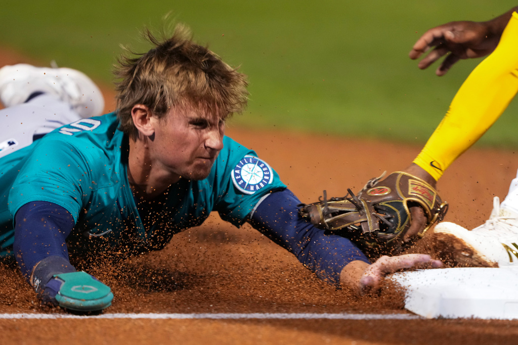 FILE - Seattle Mariners' Colt Emerson slides safely into third on a single from Samad Taylor during the second inning of a spring training baseball game against the San Diego Padres, Feb. 28, 2025, in Peoria, Ariz. (AP Photo/Lindsey Wasson, File)
