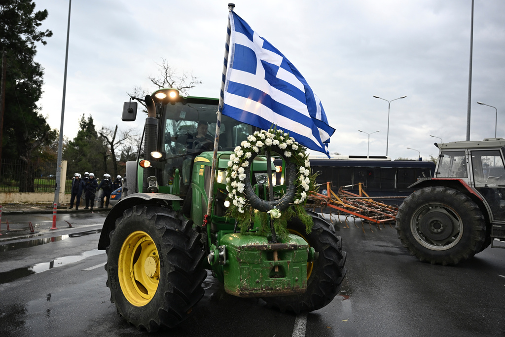 Farmers with their tractors try to block the main access road to Thessaloniki's international airport, northern Greece, Friday, Dec. 5, 2025, as protests over delays in European Union-backed agricultural subsidy payments escalated. (AP Photo/Giannis Papanikos)
