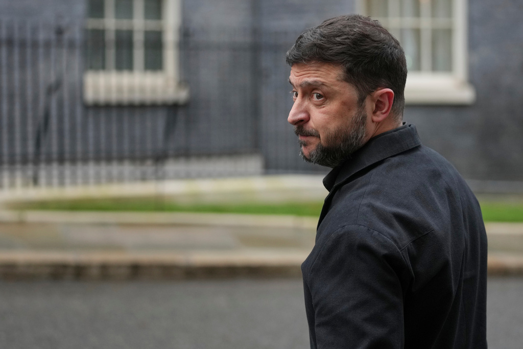 FILE - Ukrainian President Volodymyr Zelenskyy, looks back at the media in Downing Street, London, Monday, Dec. 8, 2025. (AP Photo/Kin Cheung, File)
