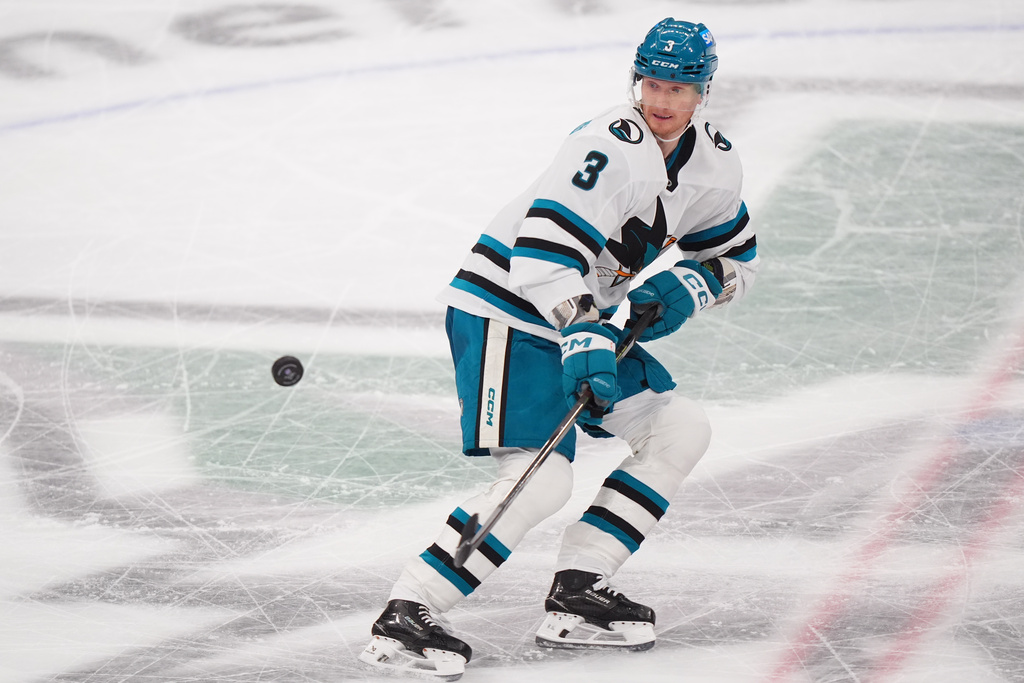 San Jose Sharks defenseman John Klingberg reaches for the puck during the second period of an NHL hockey game against the Dallas Stars, Friday, Dec. 5, 2025, in Dallas. (AP Photo/LM Otero)