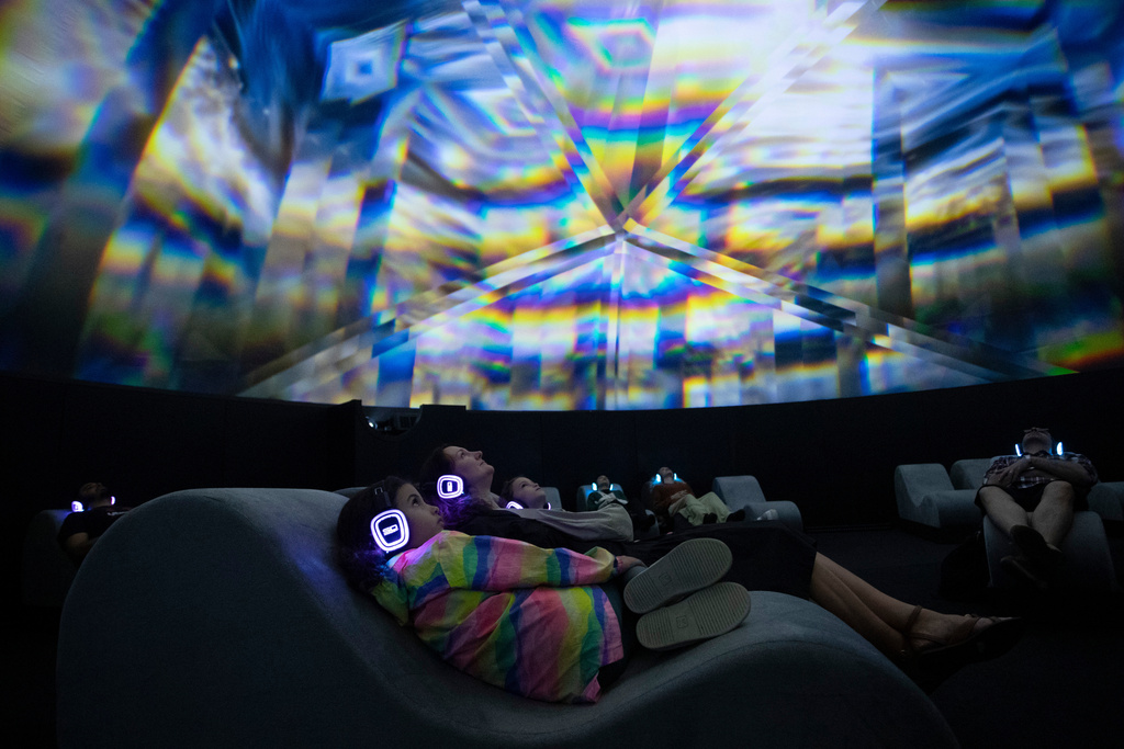 FILE - People visit an immersive, multi-sensory installation titled "The Lumisphere Experience" at the Museum of Tomorrow, ahead of COP30, the 30th Conference of the Parties to the UN Framework Convention on Climate Change, in Rio de Janeiro, Thursday, Oct. 9, 2025. (AP Photo/Bruna Prado, File)