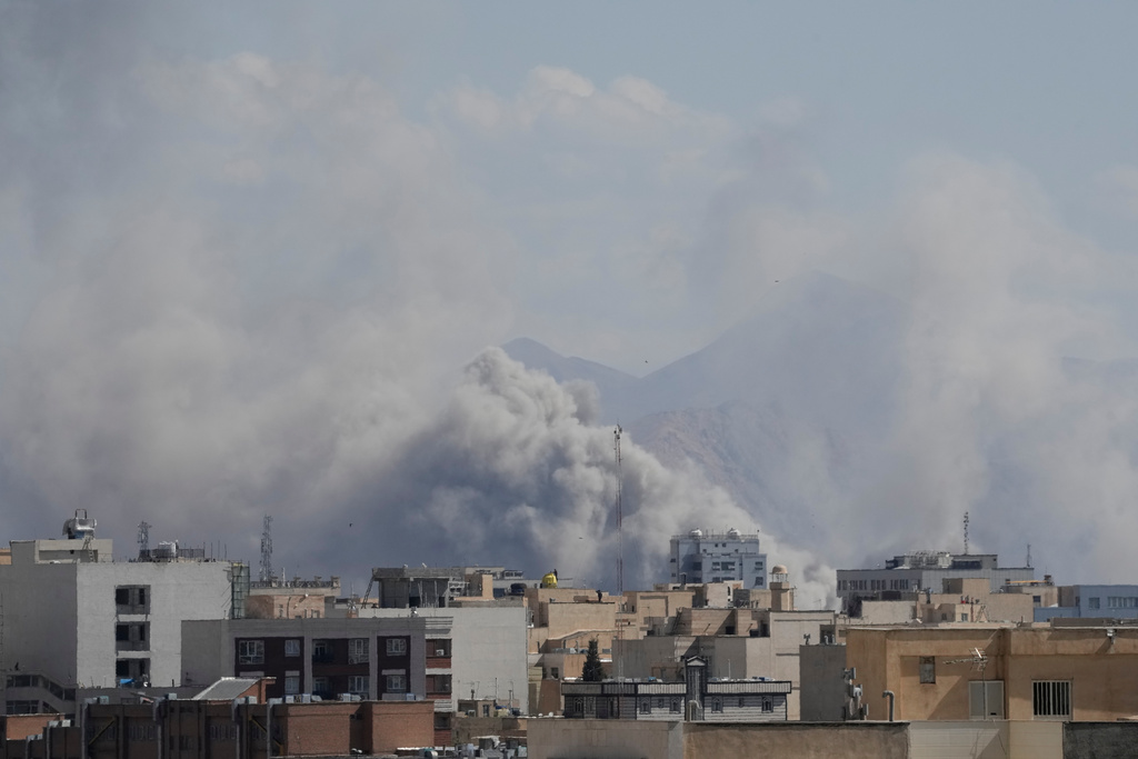 Smoke rises up after a strike in Tehran, Iran, Sunday, March 1, 2026. (AP Photo/Vahid Salemi)