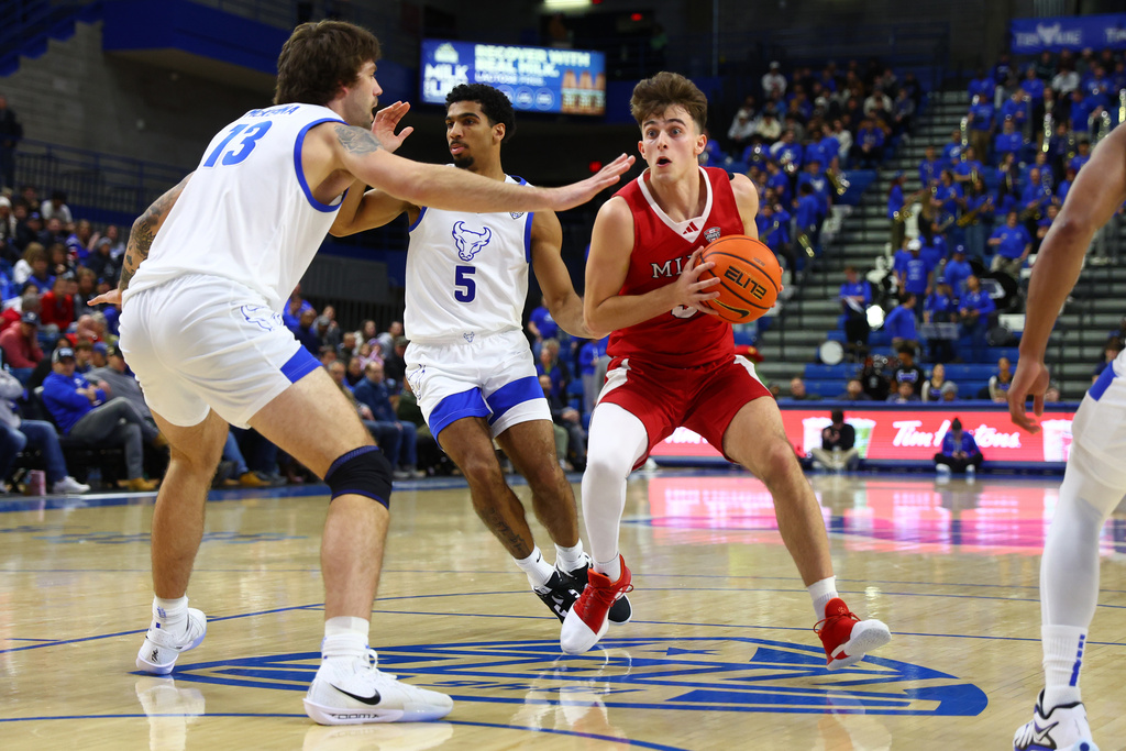 Miami (OH) guard Luke Skaljac (3) drives to the net infront pf Buffalo forward Ezra McKenna (13) during the first half of an NCAA college basketball game Tuesday, Feb. 3, 2026, in Buffalo, N.Y. (AP Photo/Jeffrey T. Barnes)