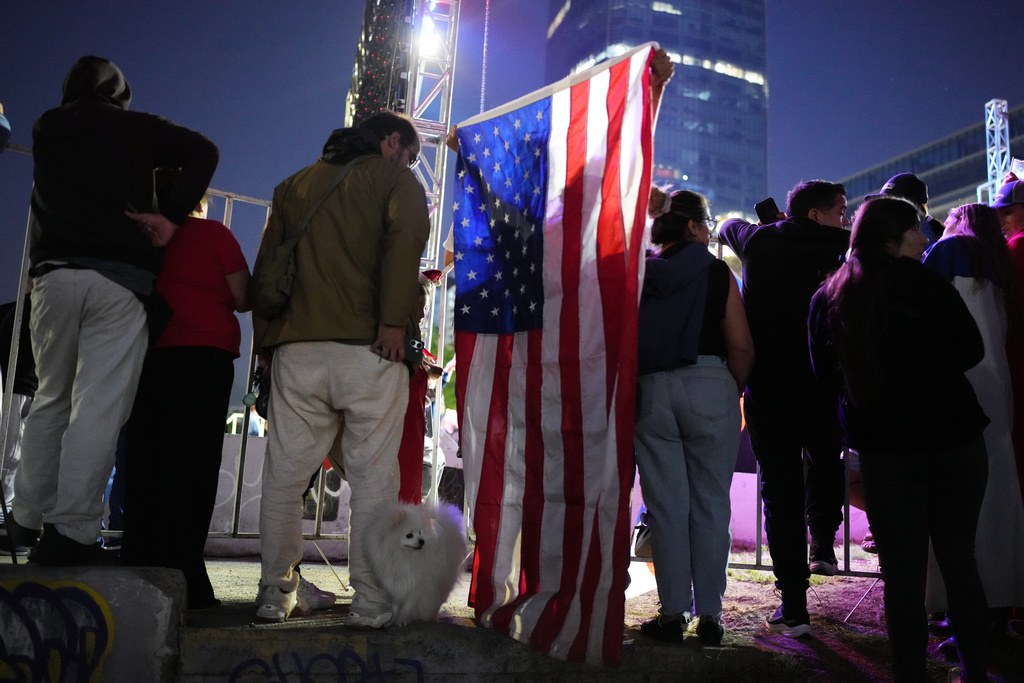Supporters listen to Presidential candidate Jose Antonio Kast, of the opposition Republican Party, delivering his victory speech after winning the presidential runoff election in Santiago, Chile, Sunday, Dec. 14, 2025. (AP Photo/Natacha Pisarenko)