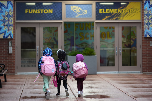 Three sisters, whose single mother fears being mistakenly detained by federal immigration agents because she is of Puerto Rican descent and speaks Spanish, walk into Funston Elementary School after being dropped off for the start of the school day, in Chicago's Logan Square neighborhood, Wednesday, Oct. 15, 2025. (AP Photo/Rebecca Blackwell) Three sisters, whose single mother fears being mistakenly detained by federal immigration agents because she is of Puerto Rican descent and speaks Spanish, walk into Funston Elementary School after being dropped off for the start of the school day, in Chicago's Logan Square neighborhood, Wednesday, Oct. 15, 2025. (AP Photo/Rebecca Blackwell)