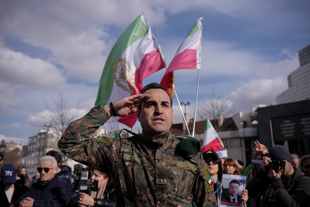 Former Iranian military member Samuel Davoud, 40, gestures during a demonstration in reaction to the U.S. and Israeli strikes on Iran on Sunday, March 1, 2026, in Paris, France. (AP Photo/Aurelien Morissard)