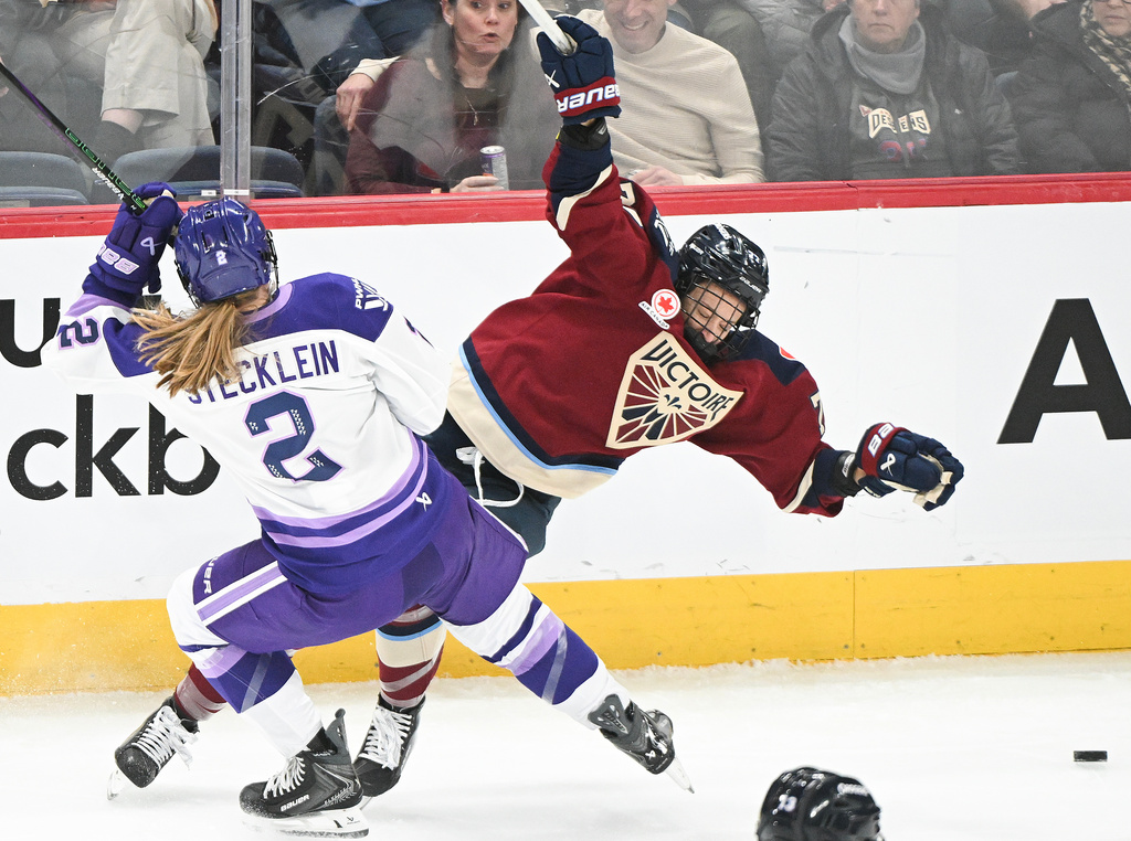Minnesota Frost's Lee Stecklein (2) collides with Montreal Victoire's Jade Downie-Landry, right, during first-period PWHL hockey game action in Laval, Quebec, Sunday, Jan. 4, 2026. (Graham Hughes/The Canadian Press via AP)