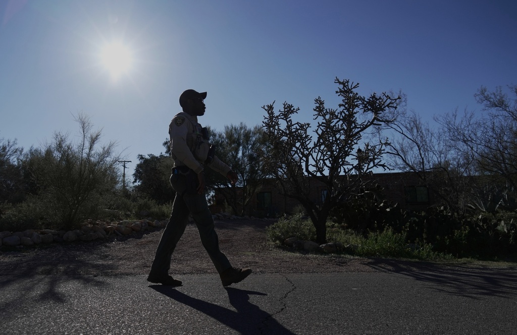 A member of the Pima County sheriffs office remains outside of Nancy Guthrie's home, Monday, Feb. 9, 2026 in Tucson, Ariz. (AP Photo/Ty ONeil)