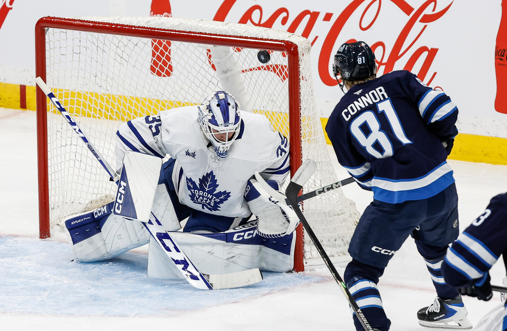 Winnipeg Jets' Kyle Connor (81) scores against Toronto Maple Leafs goaltender Dennis Hildeby (35) during second-period NHL hockey game action in Winnipeg, Manitoba, Saturday, Jan. 17, 2026. (John Woods/The Canadian Press via AP)