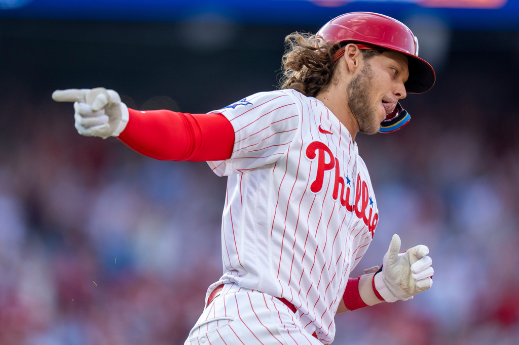 Philadelphia Phillies' Alec Bohm reacts to his three-run home run during the fifth inning of an opening-day baseball game against the Texas Rangers, Thursday, March 26, 2026, in Philadelphia. (AP Photo/Chris Szagola)