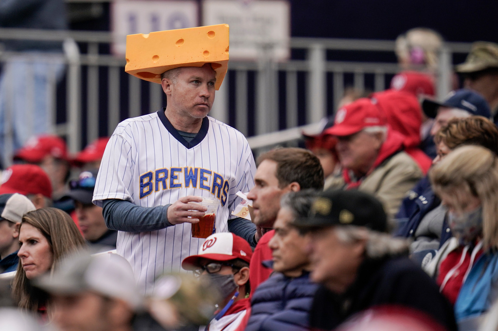 FILE. - A spectator wears a Milwaukee Brewers jersey and a cheesehead hat during the fifth inning of a baseball game between the Washington Nationals and the Brewers, May 30, 2021, in Washington. (AP Photo/Julio Cortez, File)