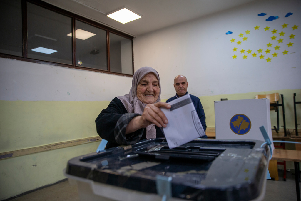 Voters cast their ballot for the municipal elections in Pristina, Kosovo on Sunday, Oct. 12, 2025. (AP Photo/Visar Kryeziu)