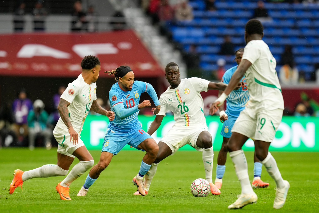 Senegal's Pape Alassane Gueye nd DR Congo's Theo Bongonda compete for the ball during the Africa Cup of Nations group D soccer match between Senegal and DR Congo in Tangier, Morocco, Saturday, Dec. 27, 2025. (AP Photo/Themba Hadebe)